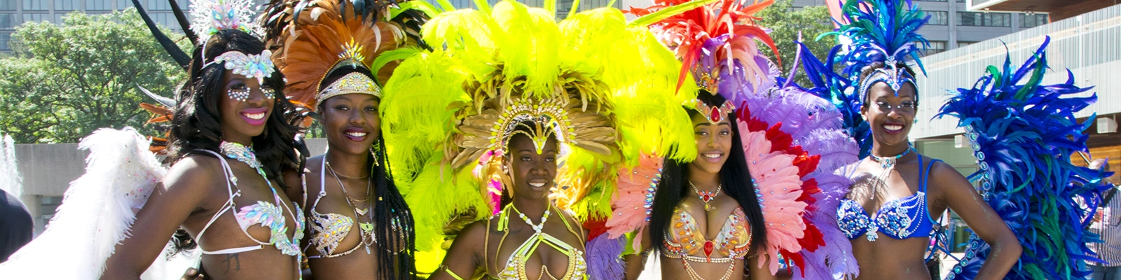A vibrant Caribana celebration with people in colorful costumes enjoying the lively Caribbean festival atmosphere.