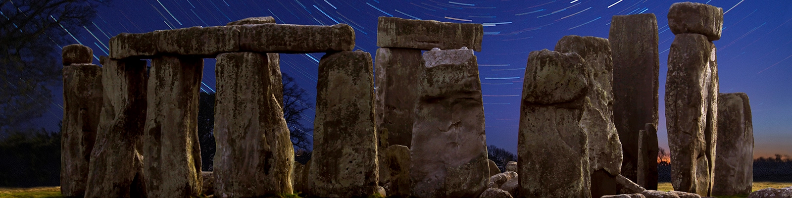Stonehenge at night with circular star trails.