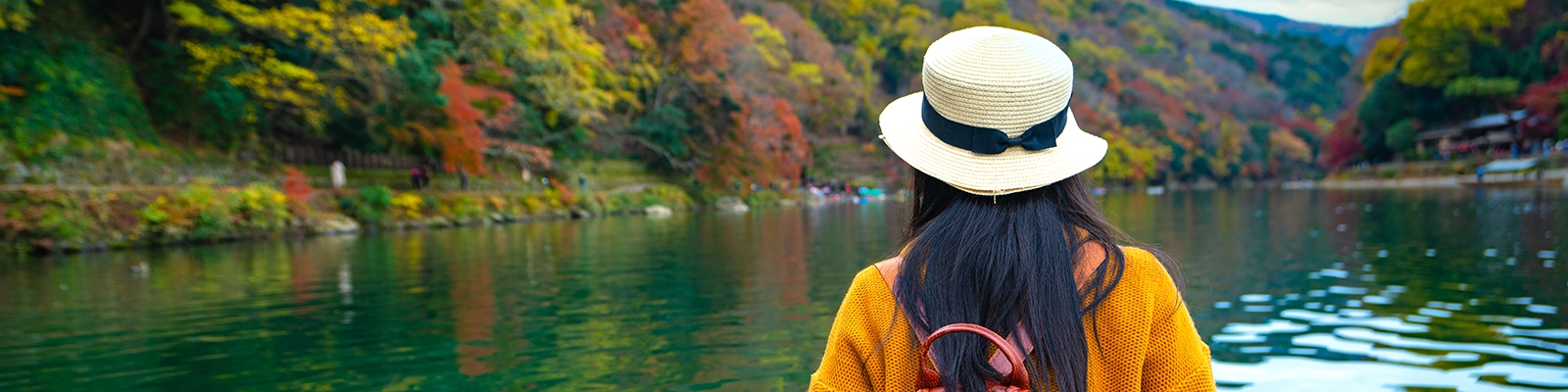 Boat ride on the Hozu River in Kyoto, Japan - a scenic waterway surrounded by lush forests and mountains.