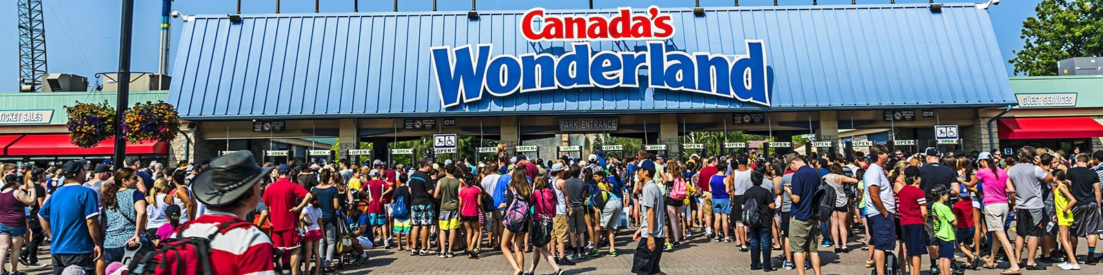 Excited visitors enjoying thrilling attractions and rollercoasters at Canada's Wonderland amusement park.