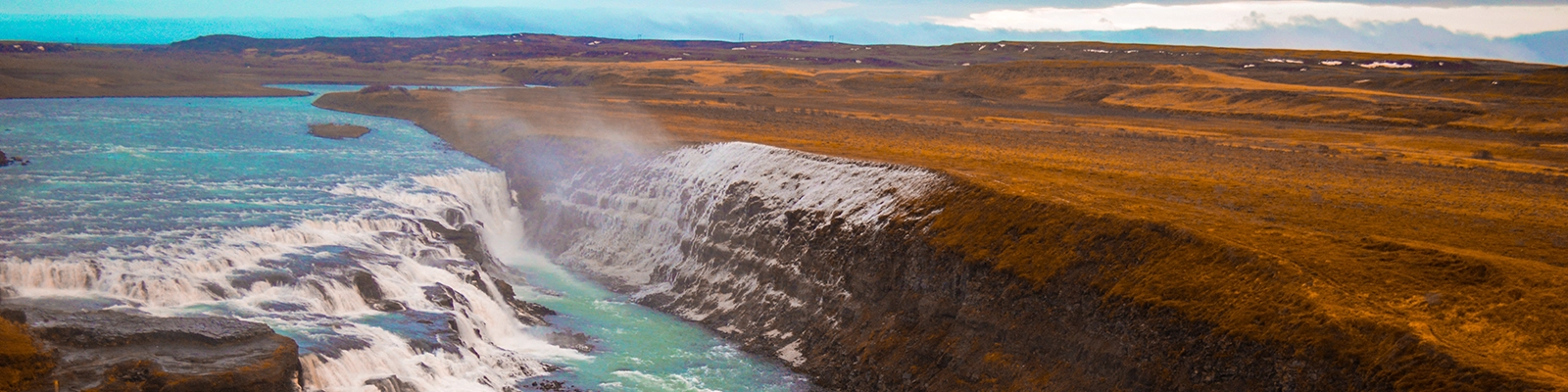 Stunning Gullfoss waterfalls in Iceland with cascading water and lush green landscape