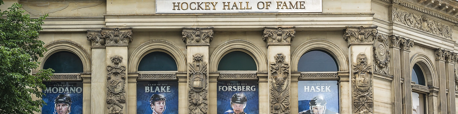Hockey Hall of Fame entrance with famous players' statues and museum exhibits in the background