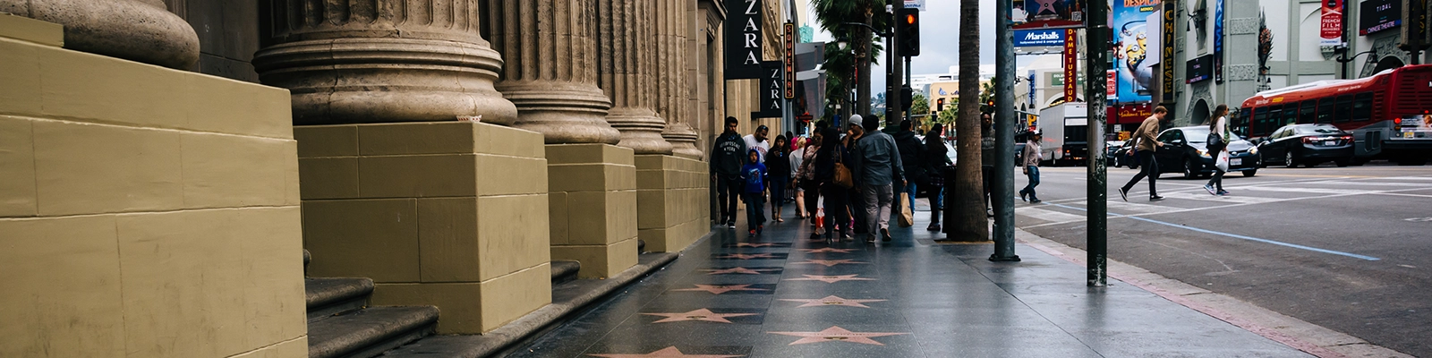 Group of tourists admiring the stars on the Hollywood Walk of Fame