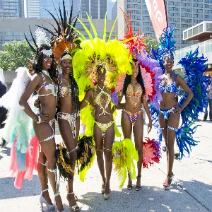 A vibrant Caribana celebration with people in colorful costumes enjoying the lively Caribbean festival atmosphere.