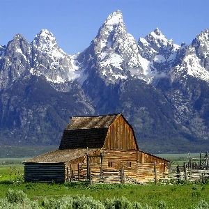 Scenic view of majestic mountain peaks and lush green landscape at Grand Teton National Park