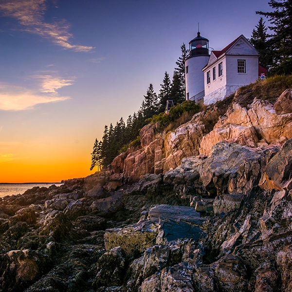 A stunning view of Acadia National Park with lush greenery, pristine lakes, and dramatic mountain landscapes.